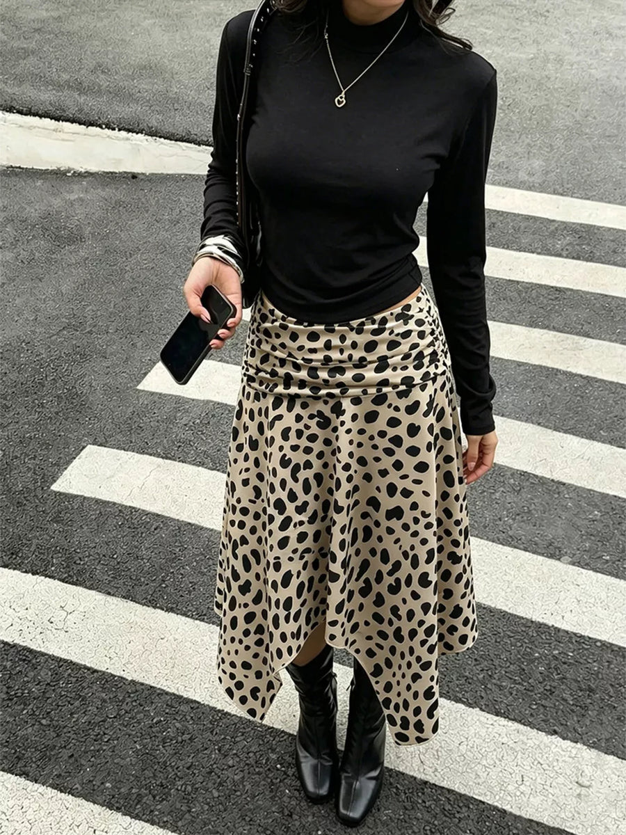 Leopard print midi skirt with asymmetrical hem and ruched side detail.
