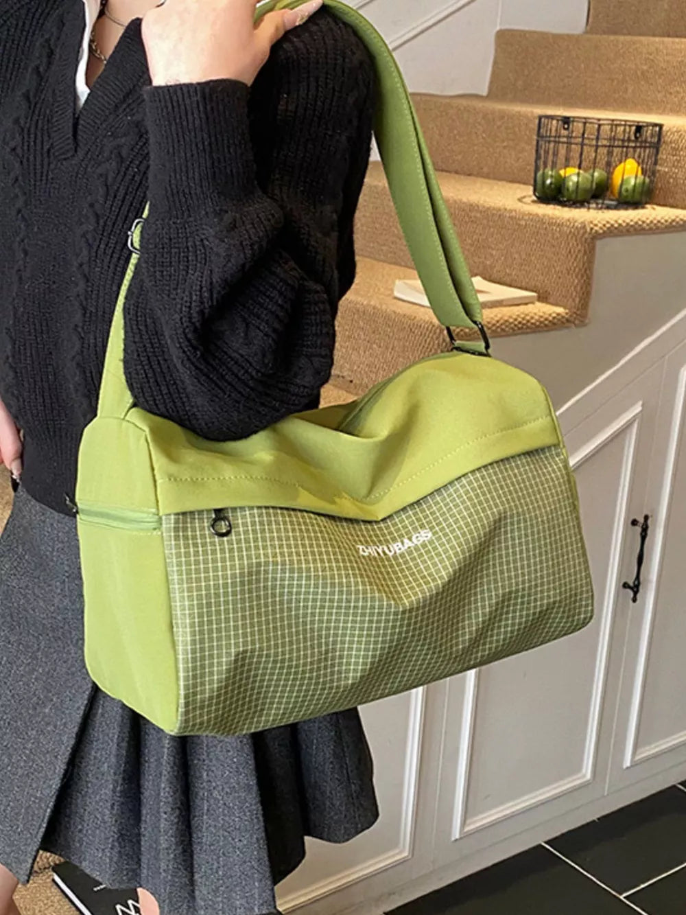 Green plaid Oxford travel bag with zipper detail and adjustable strap.
