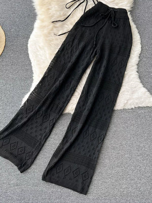 Black crochet wide-leg pants with diamond pattern and drawstring waist.