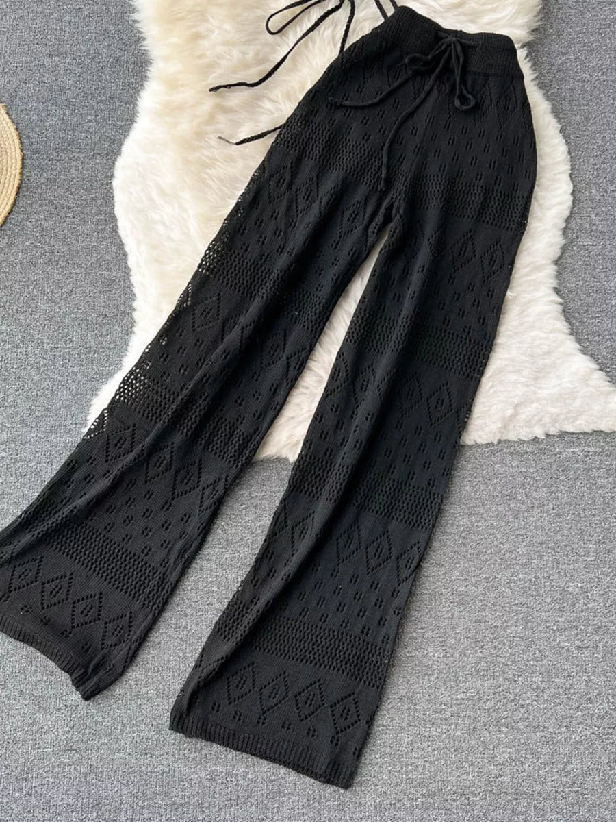 Black crochet wide-leg pants with diamond pattern and drawstring waist.