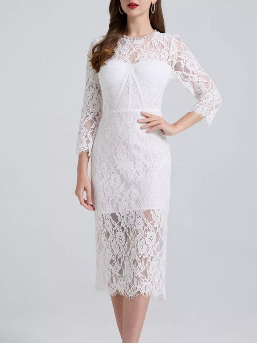 White lace midi dress with sheer sleeves and sweetheart neckline detail.