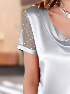Gray cowl neck blouse with sheer short sleeves adorned with white polka dots.
