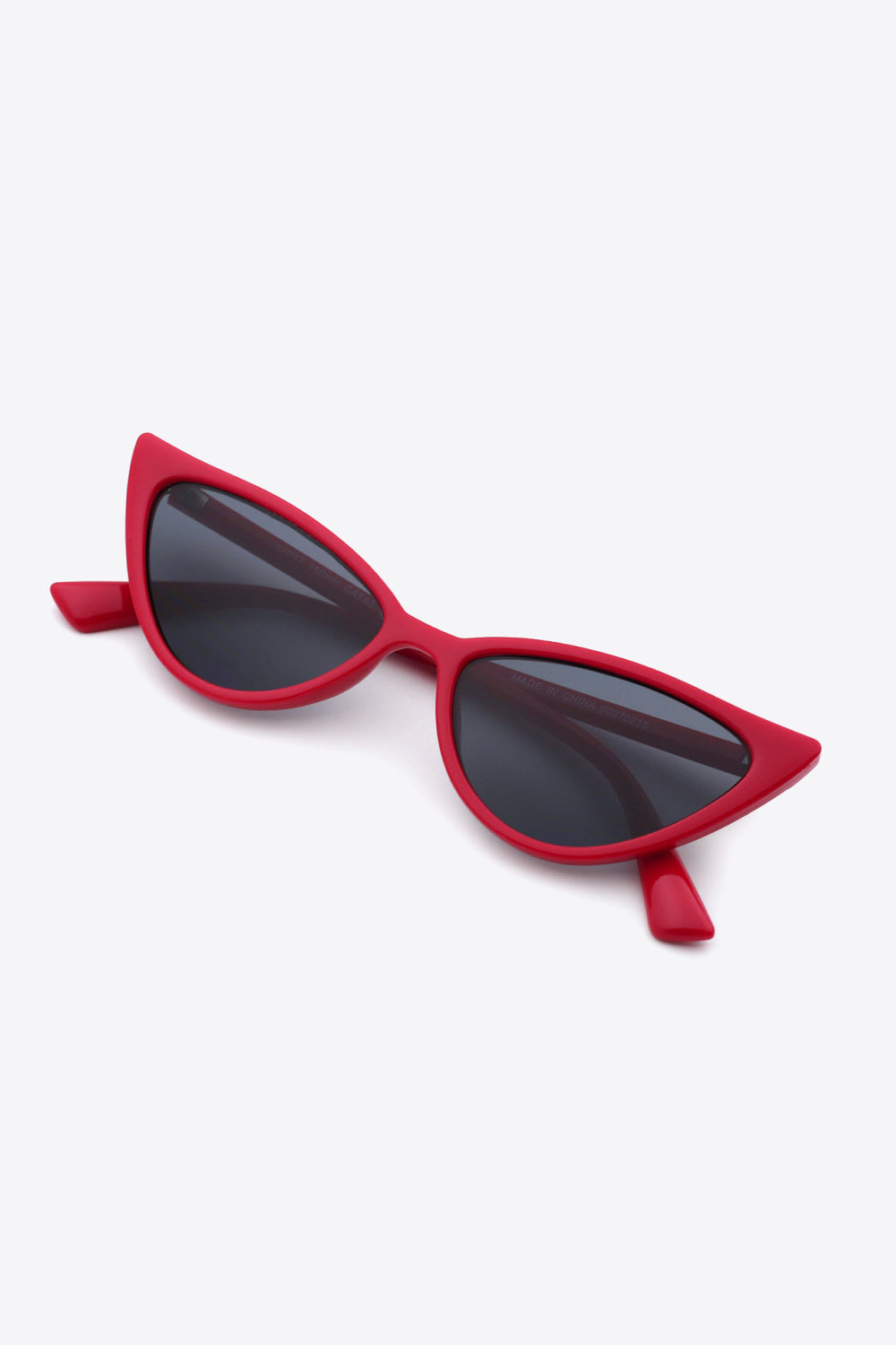 Crimson cat-eye sunglasses with dark lenses and bold frames.