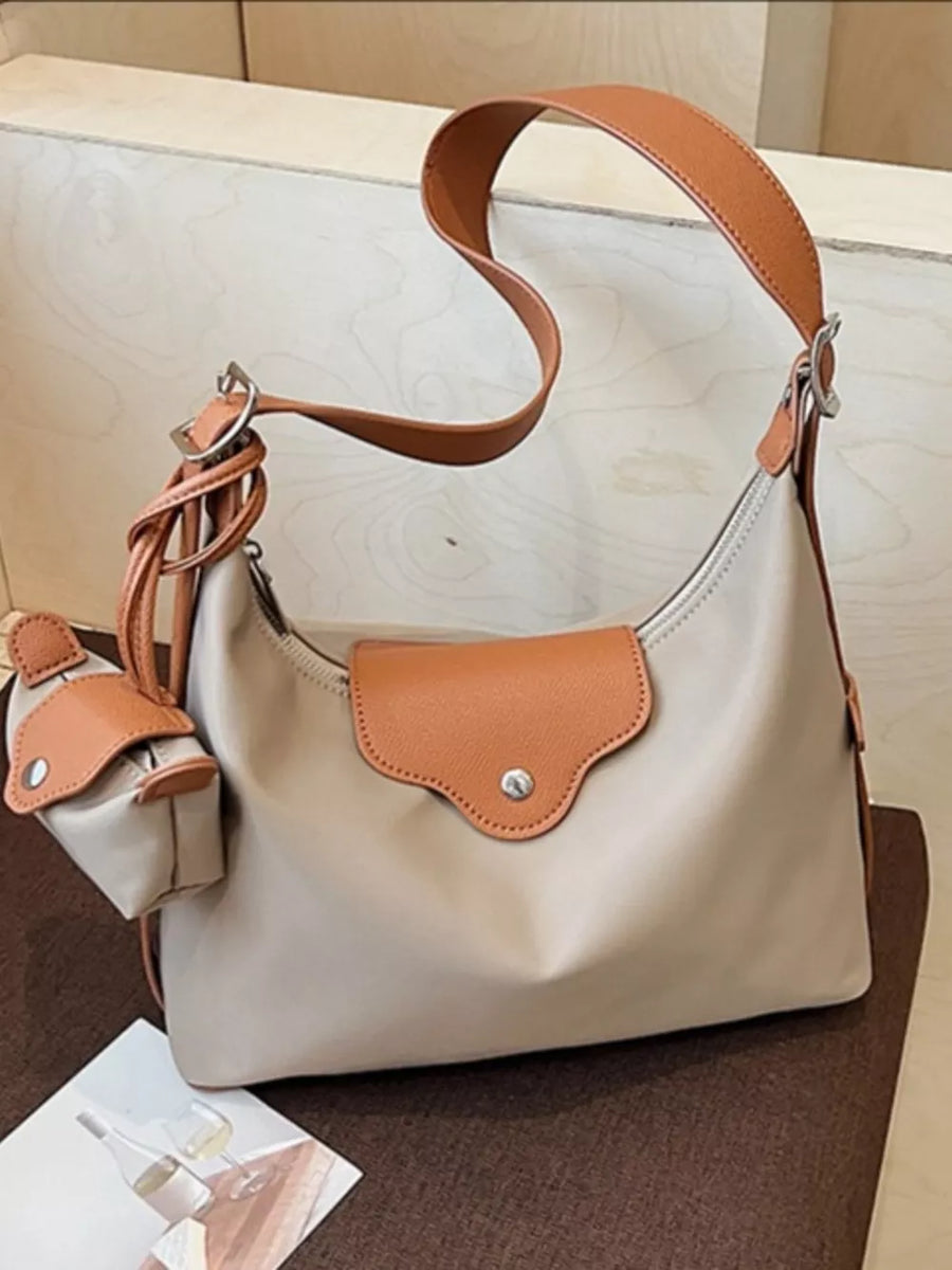 Khaki canvas hobo bag with coin purse and tan leather trim.