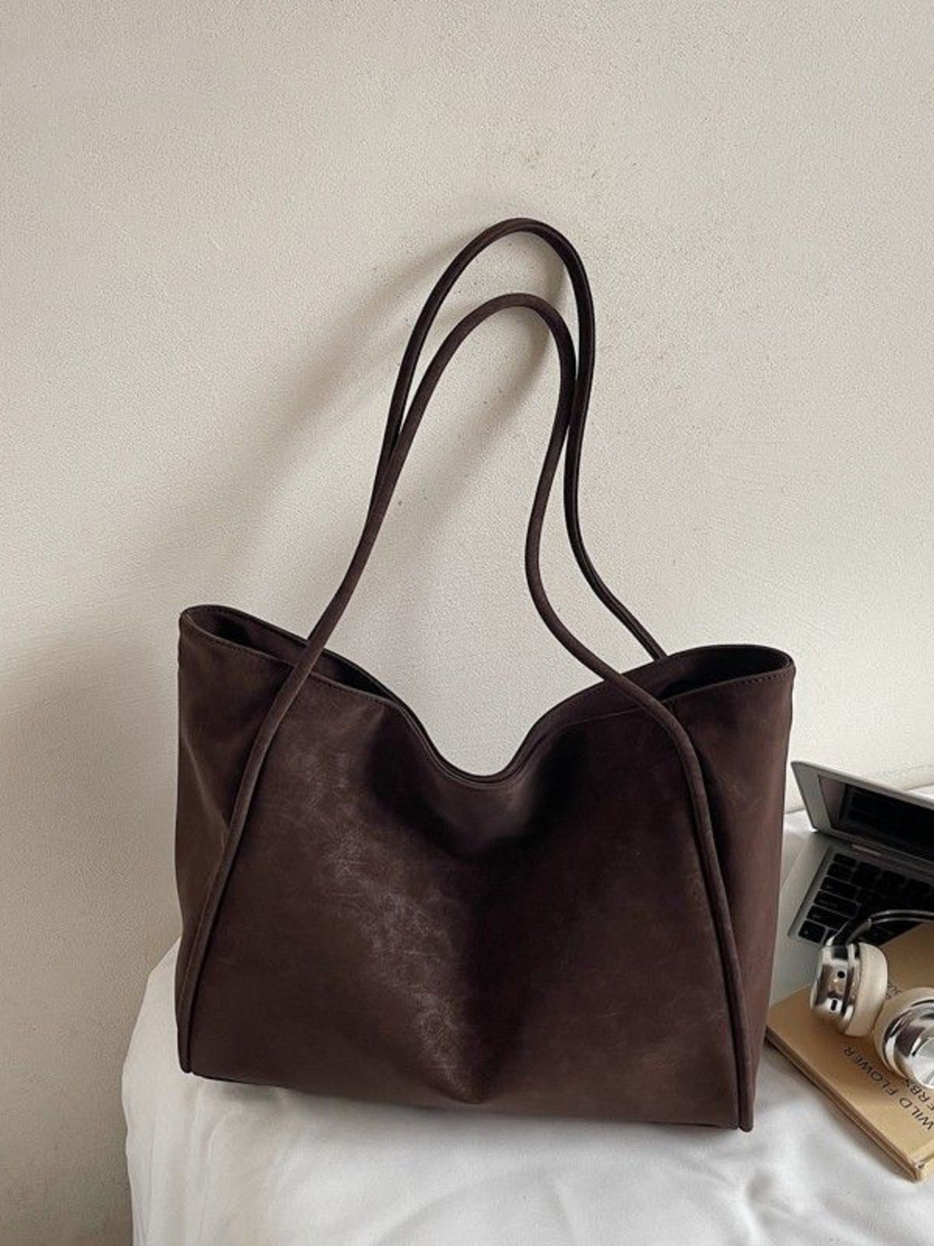 Large brown suede shoulder bag with thin straps and a subtle textured finish.