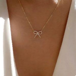 Gold bowknot pendant necklace with clear stones on a delicate chain