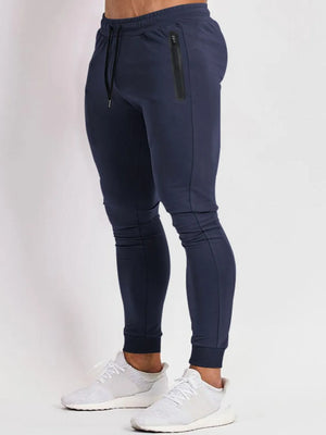 Navy slim fit tech joggers with zip pocket detail and drawstring waist.