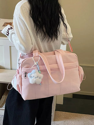 Pink quilted tote bag with zipper pockets and a fluffy star charm