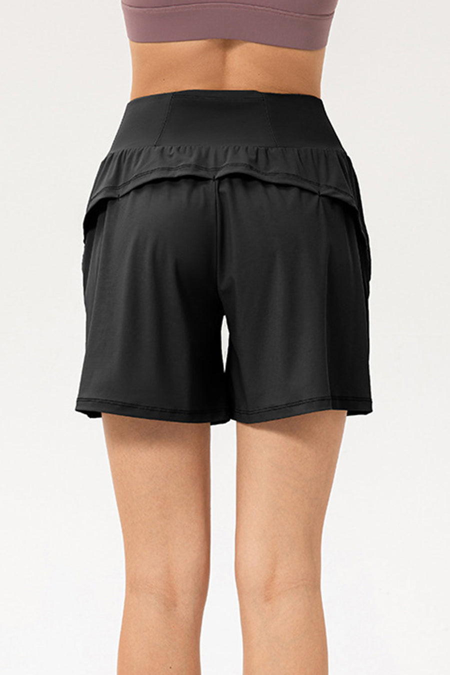 Black active layered pocket shorts with ruffled waistband detail.