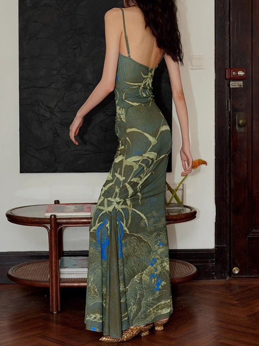 Botanical print spaghetti strap maxi dress in blue and brown with a flowing silhouette.