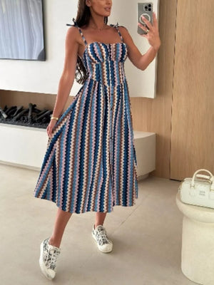 Midi dress with tie straps and zigzag stripe pattern in blue, brown, and pink.