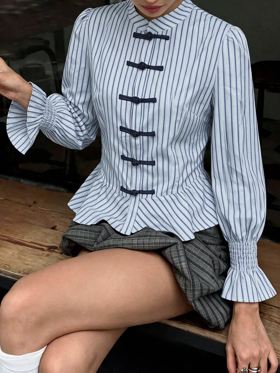 white peplum top with hip-length and knot buttons