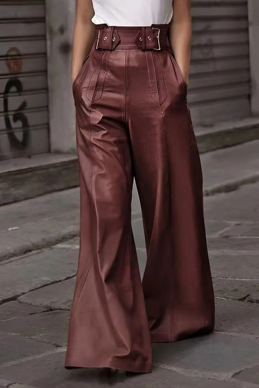 Burgundy wide-leg leather pants with a buckle belt and pleats