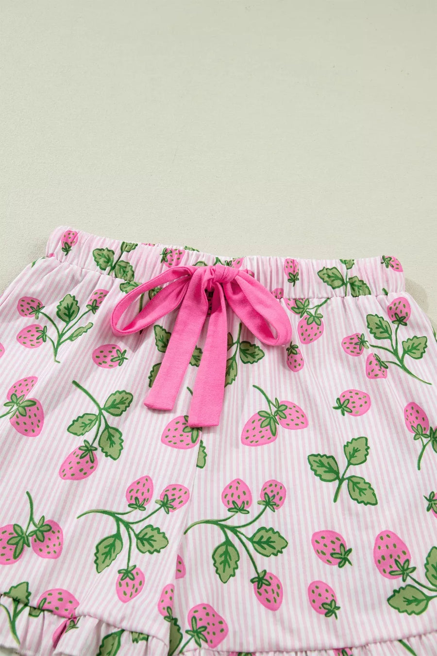 Pink striped pajama shorts with a strawberry print and drawstring waist.