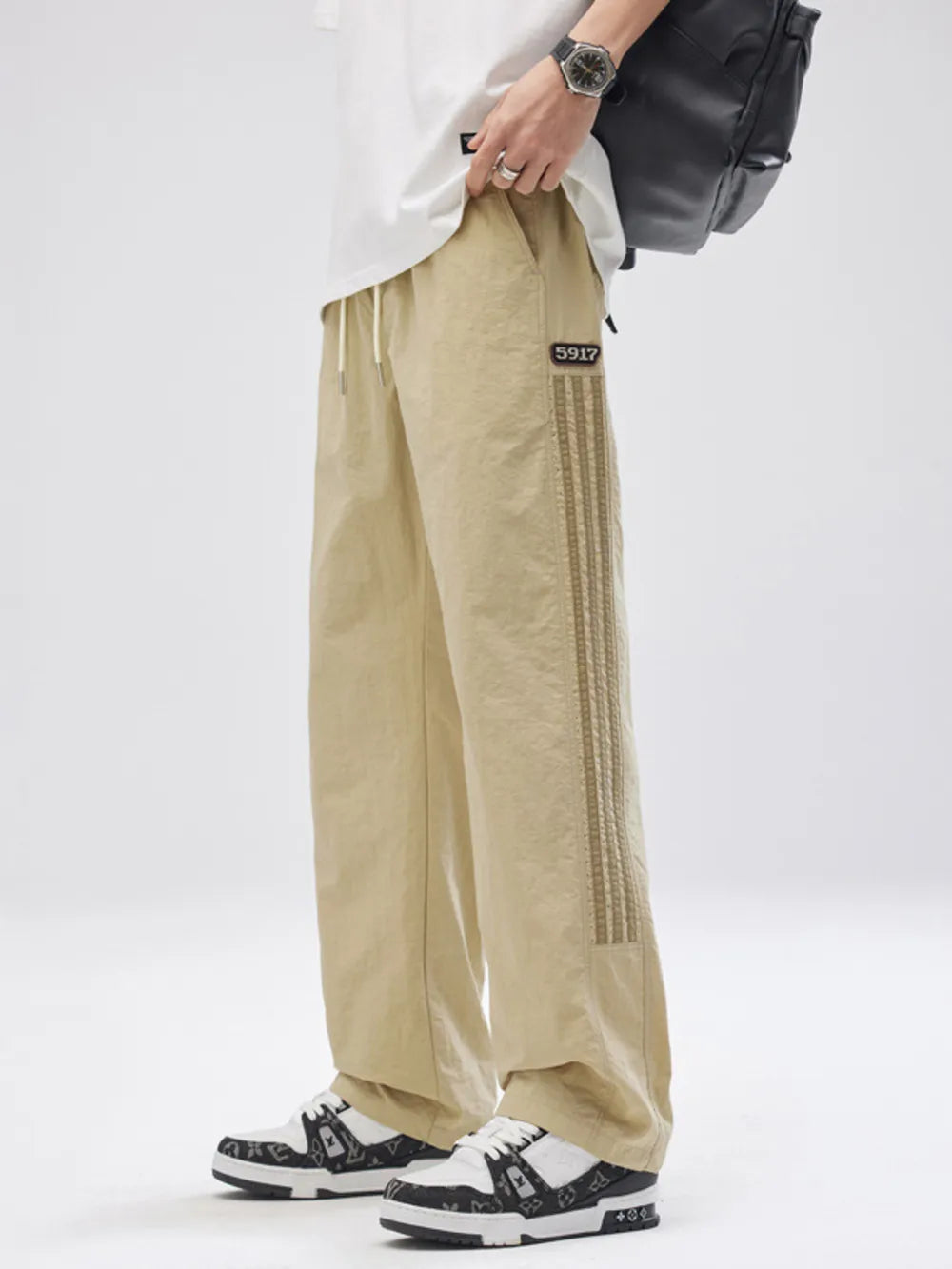 Khaki casual drawstring sweatpants with side stripe detail and patch logo