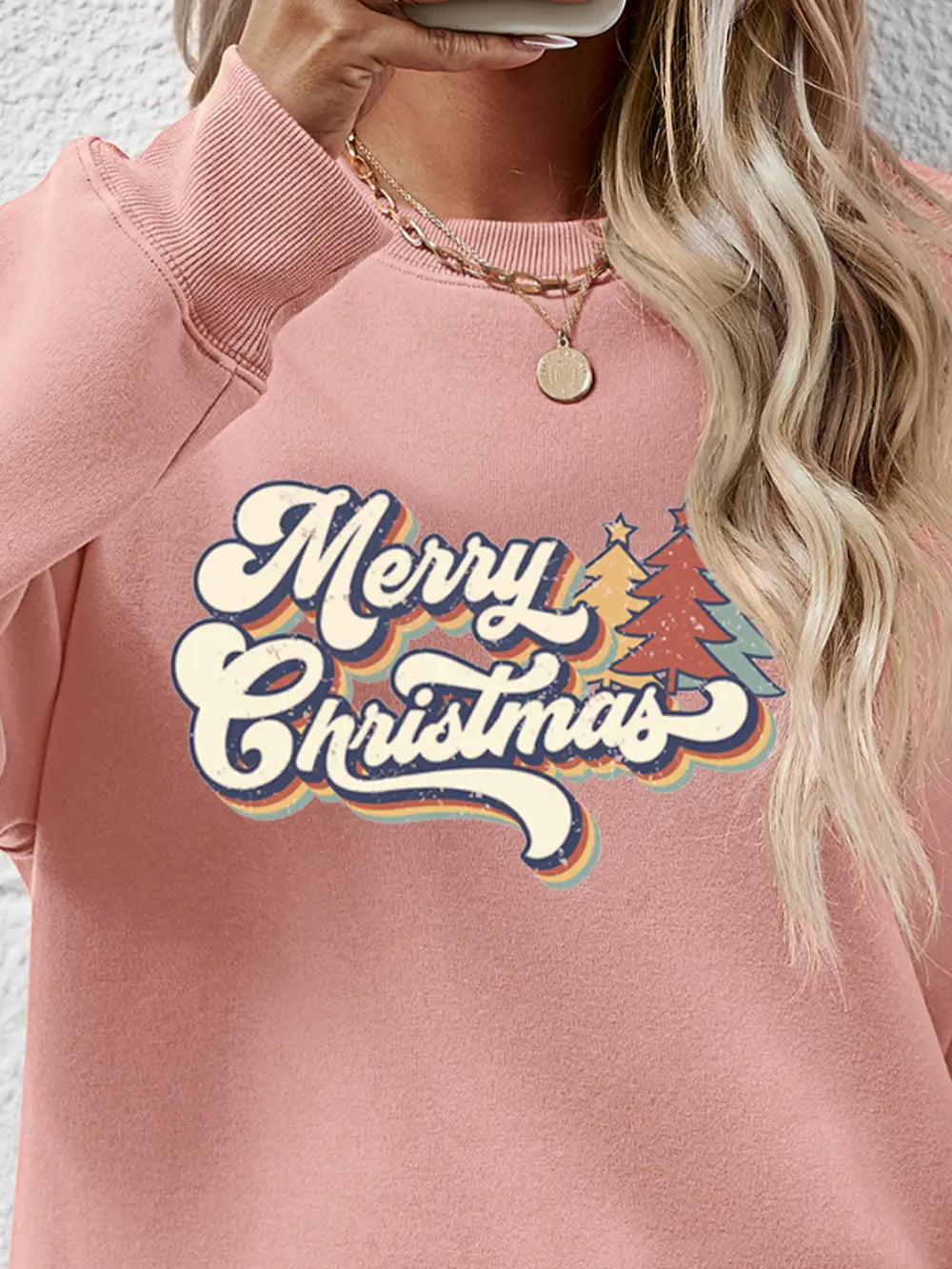 Festive Message Round Neck Sweatshirt in Blush Pink with retro Christmas trees and text graphic.
