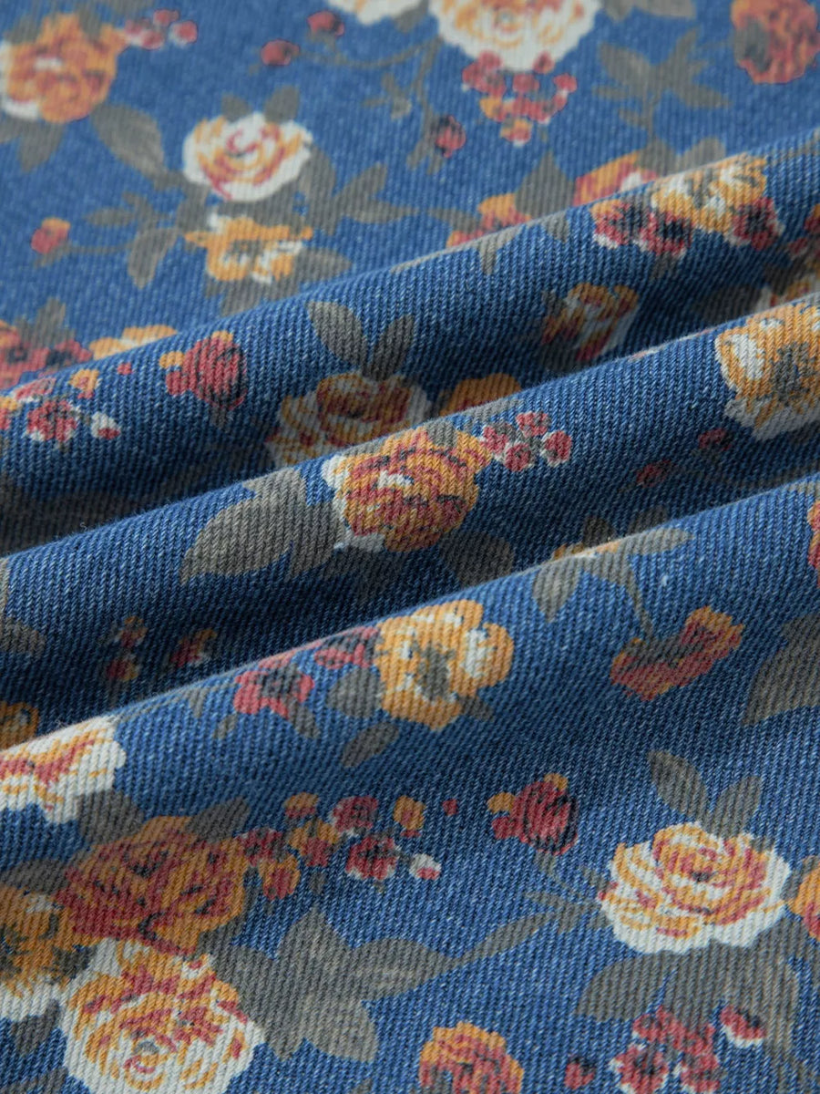 Floral denim overalls with adjustable straps and a vintage floral print.