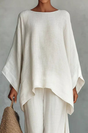 White polyester two-piece set with flowing top and wide-leg pants.