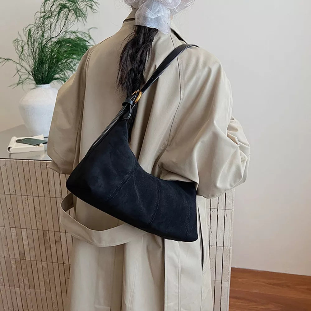 Black suede crescent shoulder bag with adjustable strap