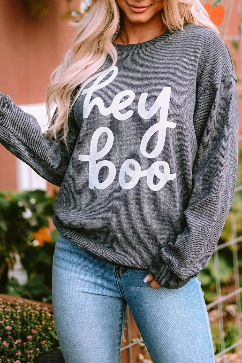 Textured dark gray sweatshirt with white "hey boo" graphic, crewneck, long sleeves, slouchy fit