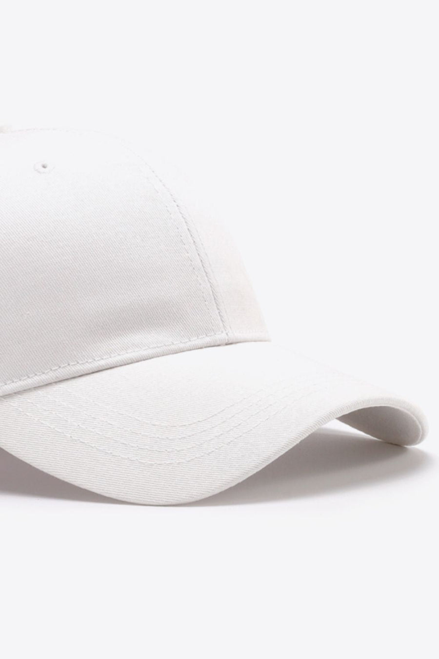 White cotton twill baseball cap with curved brim and stitched details
