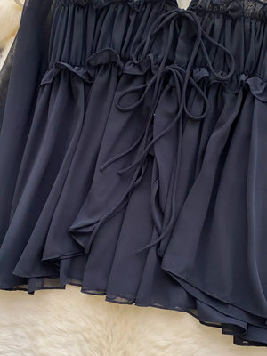 Black chiffon blouse with ruffled neckline and tie front detail