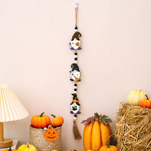 Halloween gnome charm trio garland with black, orange, and white beads and a tassel.