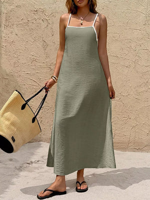 Olive spaghetti strap maxi dress with contrasting white trim and a-line cut.