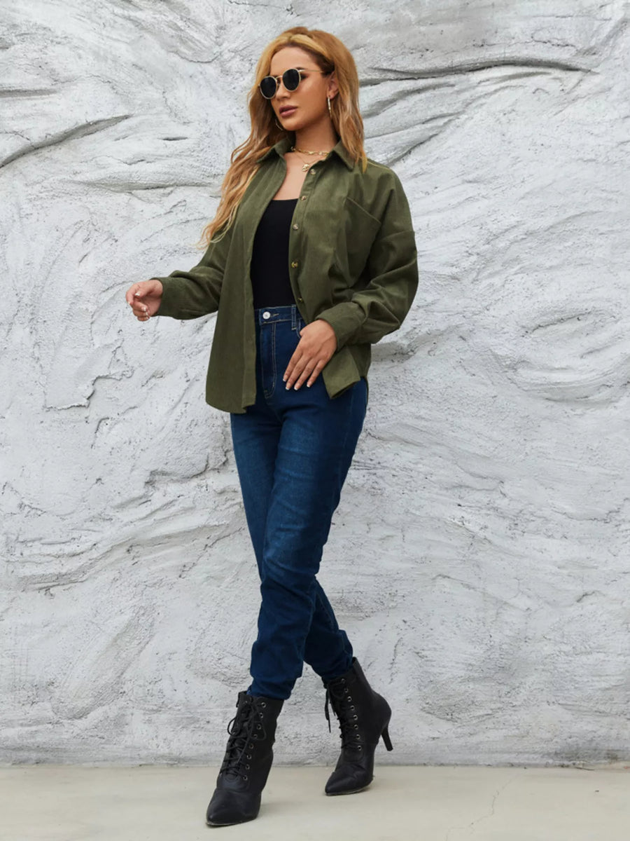 Olive green corduroy button-up shirt with a relaxed fit, worn open over a black tank top and jeans.