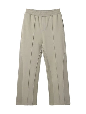 Beige lounge trousers with vertical seam details and a wide leg.