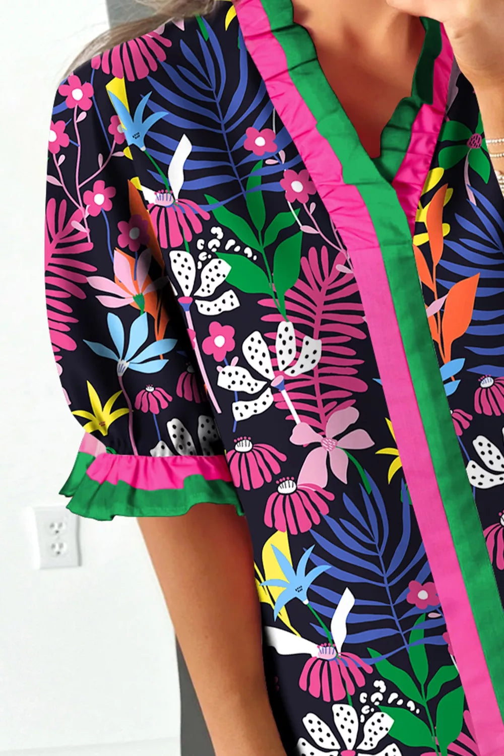 Floral frill v-neck shirt with striped accents and ruffled sleeves.