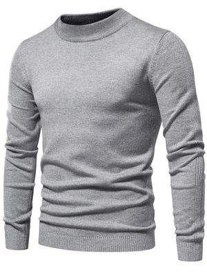 Gray ribbed mock neck sweater with sculpted shoulder detail and ribbed cuffs and hem.