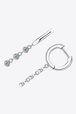 Silver hoop earrings with dangling chain featuring three clear gemstones and a bar accent.