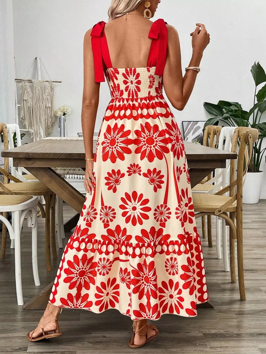 Red floral midi dress with tie shoulders and smocked bodice.