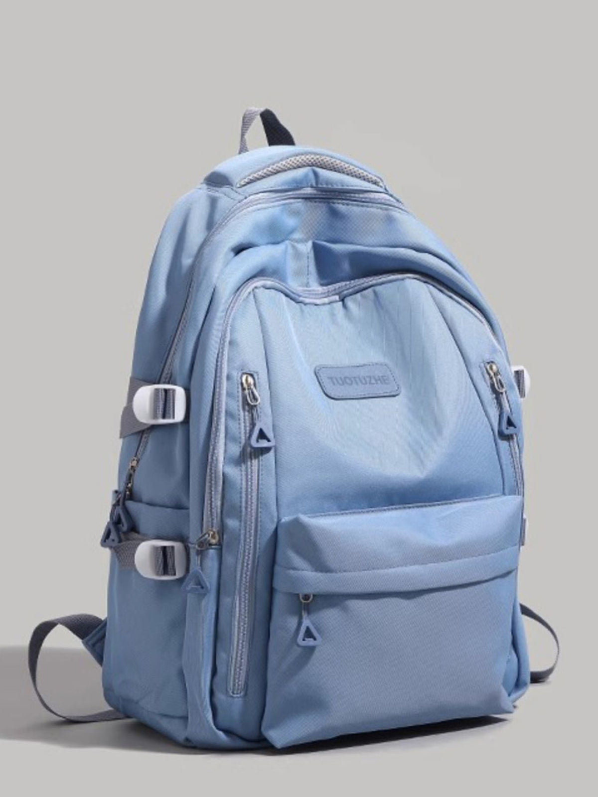 Large blue nylon backpack with multiple zippered pockets and adjustable straps.