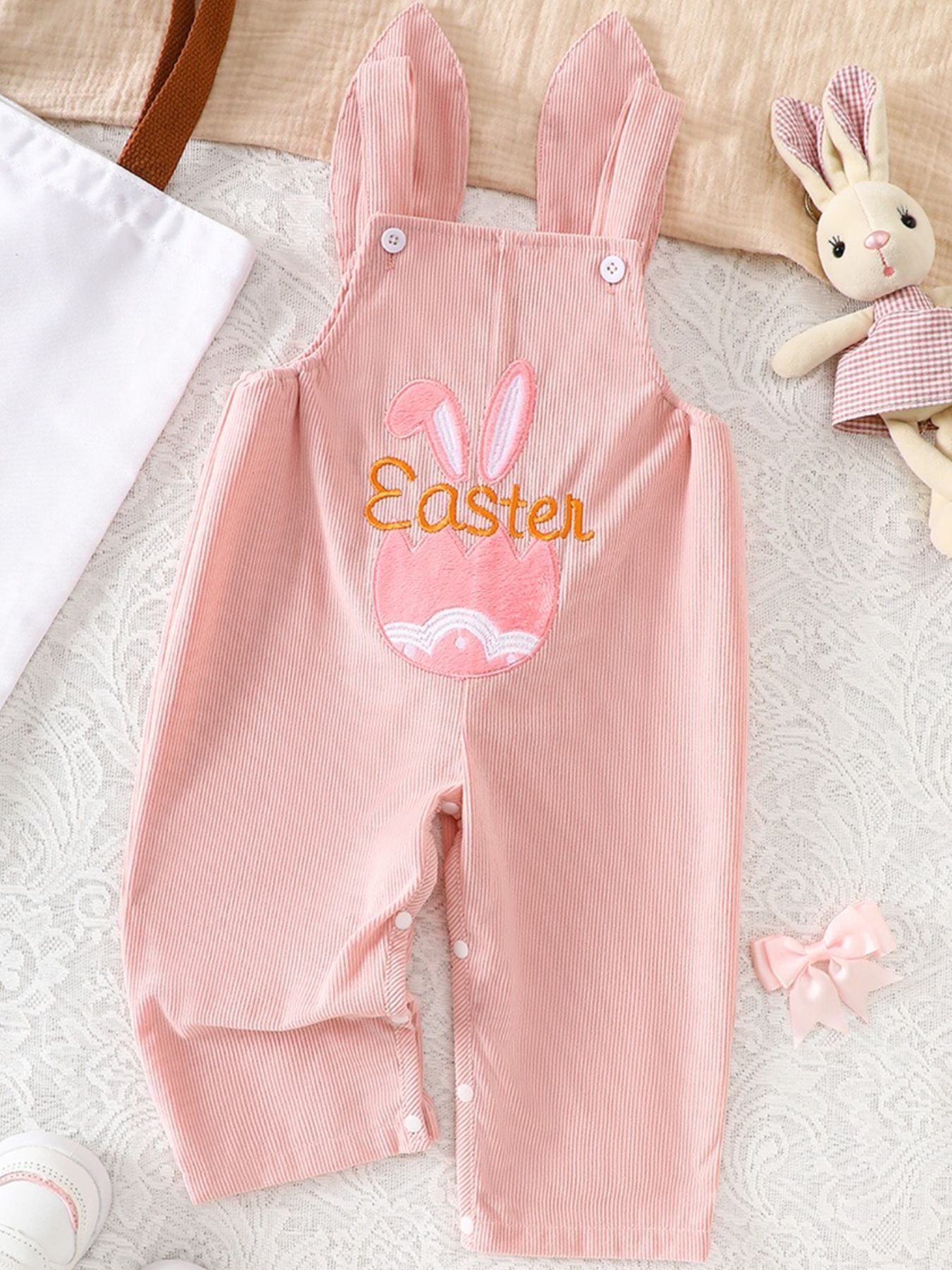 Pink corduroy baby overalls with bunny ears and Easter egg embroidery