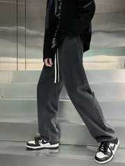 Men's gray loose-fit jeans with drawstring detail and vintage wash.