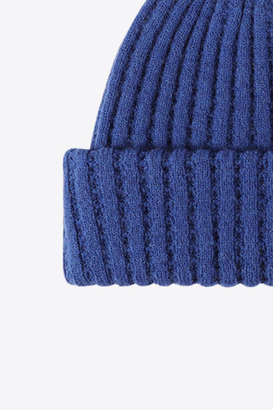 Textured ribbed knit beanie in Indigo acrylic with a cuffed hem.