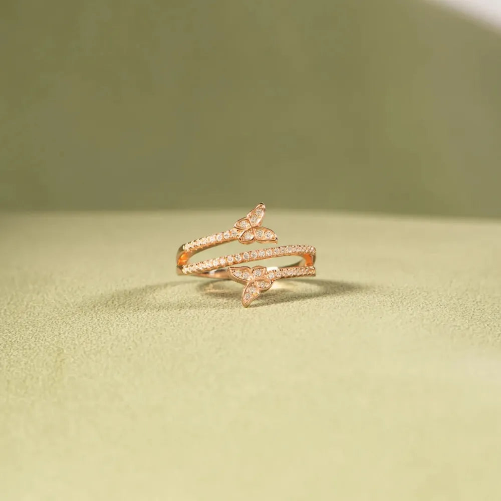Gold bypass ring with pavé butterfly details, 18K gold-plated.