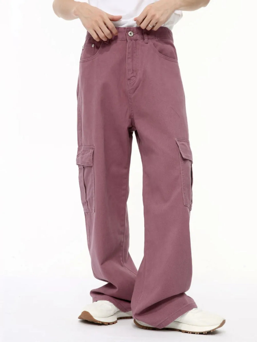 Oversized cargo denim trousers in dusty pink with multiple pockets and a relaxed fit.