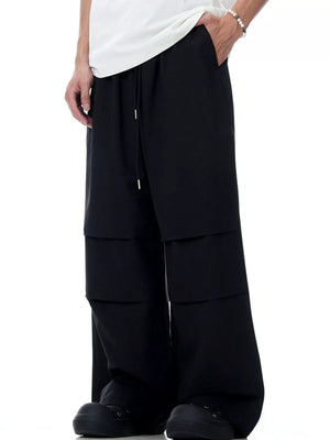 Black wide-leg drawstring jogger pants with layered detail
