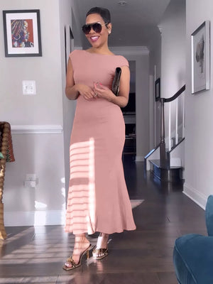 Sleek backless cap sleeve maxi gown in coral with a boat neckline and body-skimming fit.