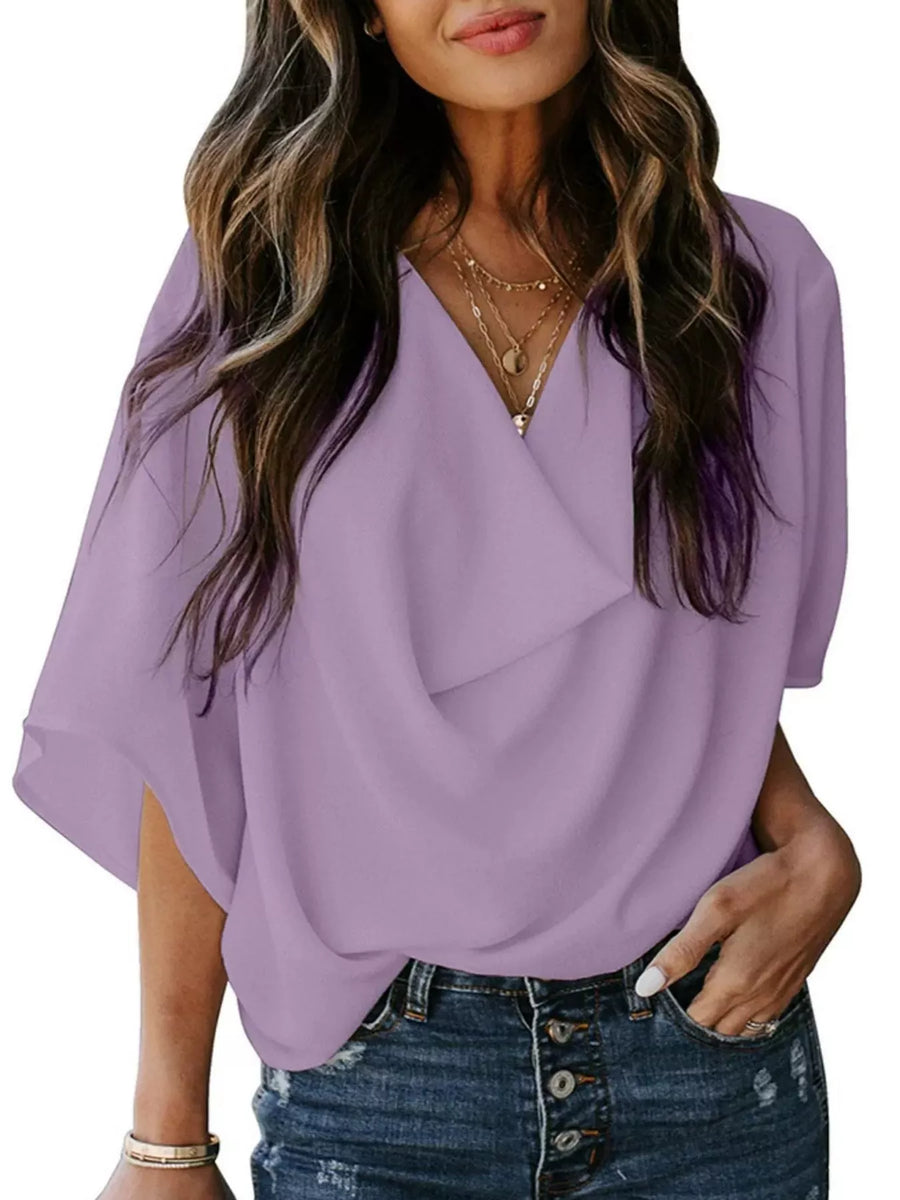 Light purple flowy half sleeve blouse with draped neckline and v-neck.