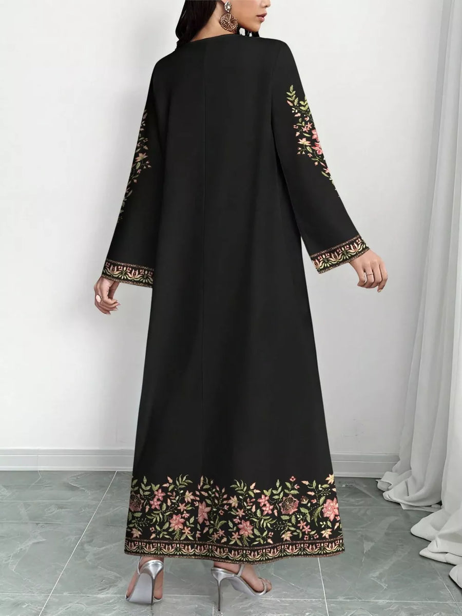Black floral embroidered maxi dress with long sleeves and ornate hem detail.