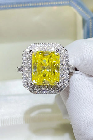 Yellow radiant cut halo ring with canary moissanite center stone and diamond accents.