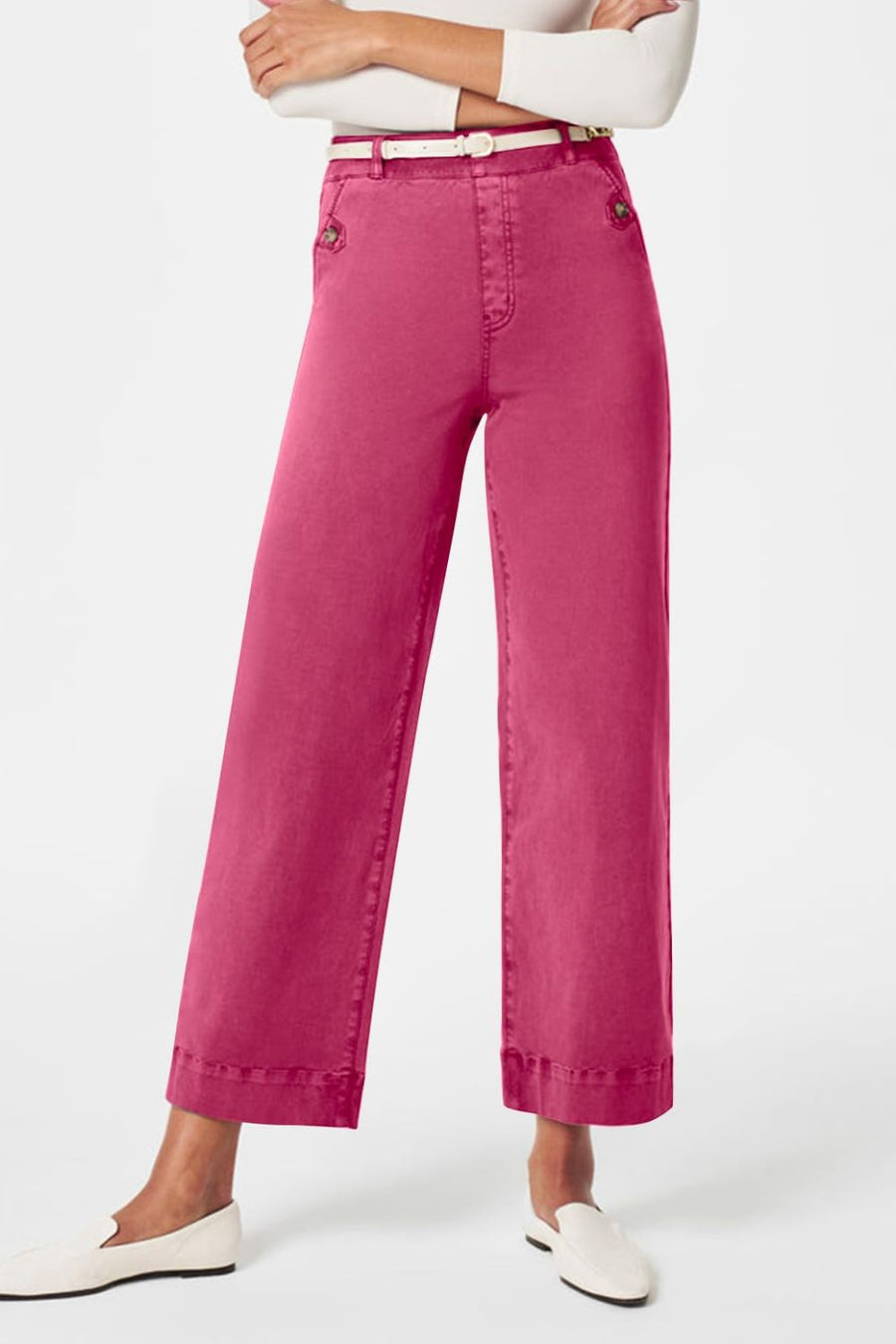 Fuchsia pink wide-leg denim trousers with buttoned pockets and a white belt.