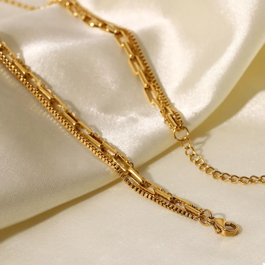 Gold necklace featuring layered and chain link