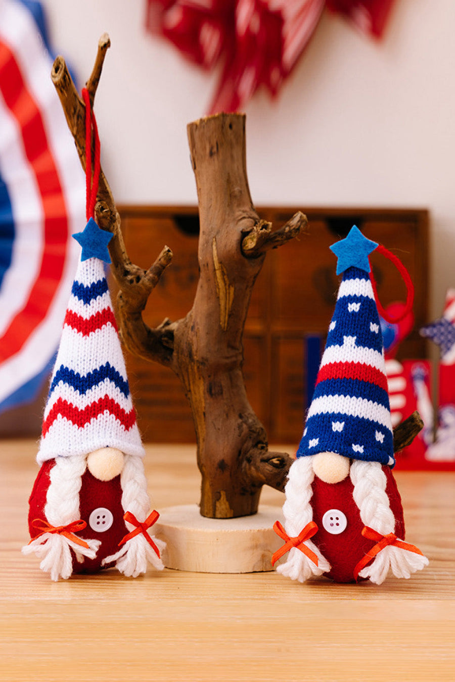 Patriotic knit gnome ornaments with red, white, and blue hats and red bodies.