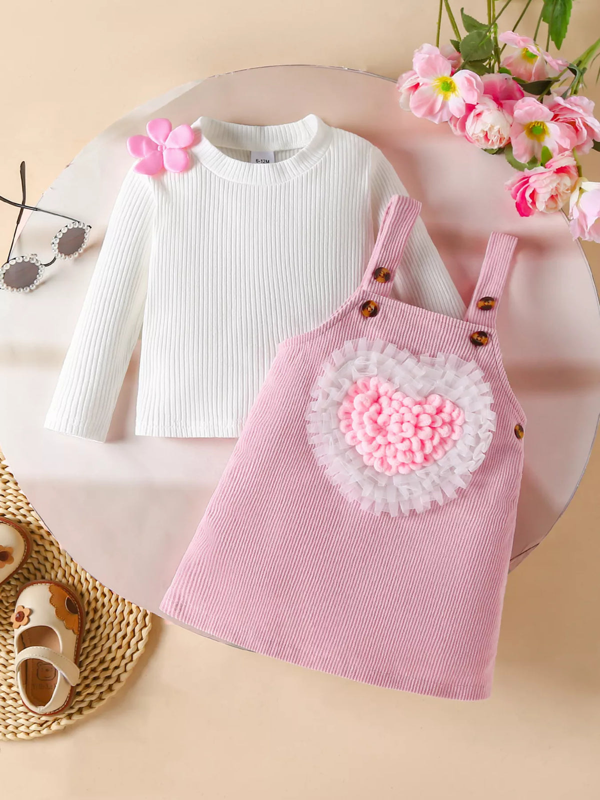 Baby corduroy pinafore dress set in blush pink with heart detail and white ribbed top.