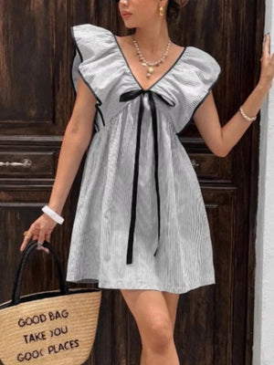 Ruffled sleeve mini dress with black bow and pinstripe pattern.